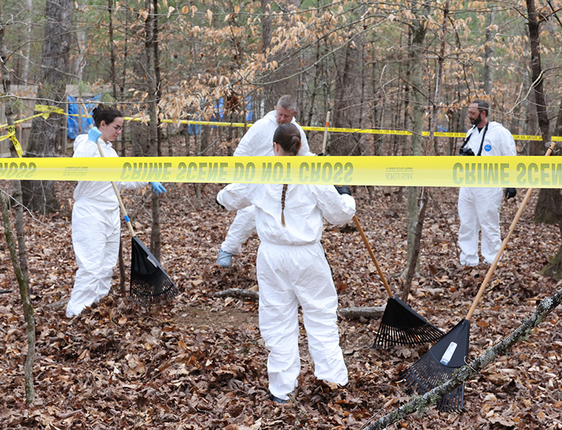 Forensic scientists work to uncover a grave at the Outdoor Forensic Training Center.
